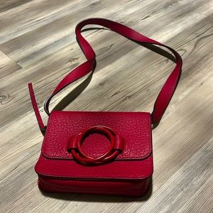 This lovely red crossbody bag is great. multiple pockets and nice size. Unworn